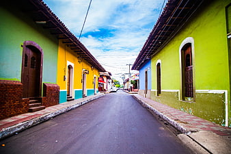 Colorful colonial street with vibrant green and yellow buildings