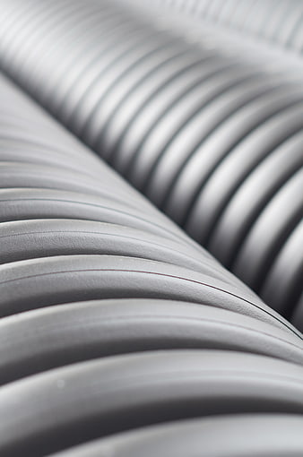Close-up of gray corrugated industrial pipes