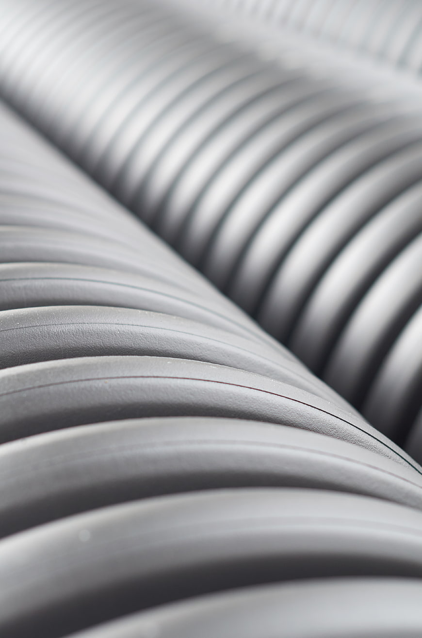 Close-up of gray corrugated industrial pipes