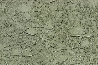 Greenish stucco wall texture with uneven plaster surface