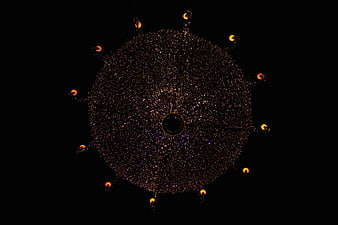 Large circular Christmas light display with starburst pattern at night