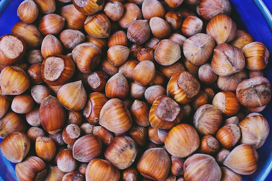 Top View of Roasted Hazelnuts in a Blue Bowl