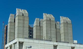 Concrete Ventilation Shafts on Modern Building Rooftop