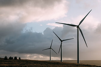 Wind Turbines on Hill Against Dramatic Cloudy Sky