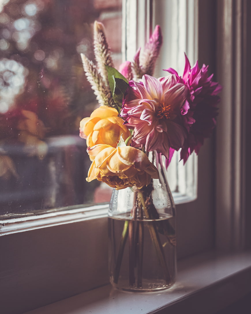 Colorful Dahlia and Rose Bouquet in Glass Vase by Window