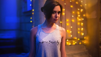 Young Woman in Positivity Tank Top with Bokeh Lights