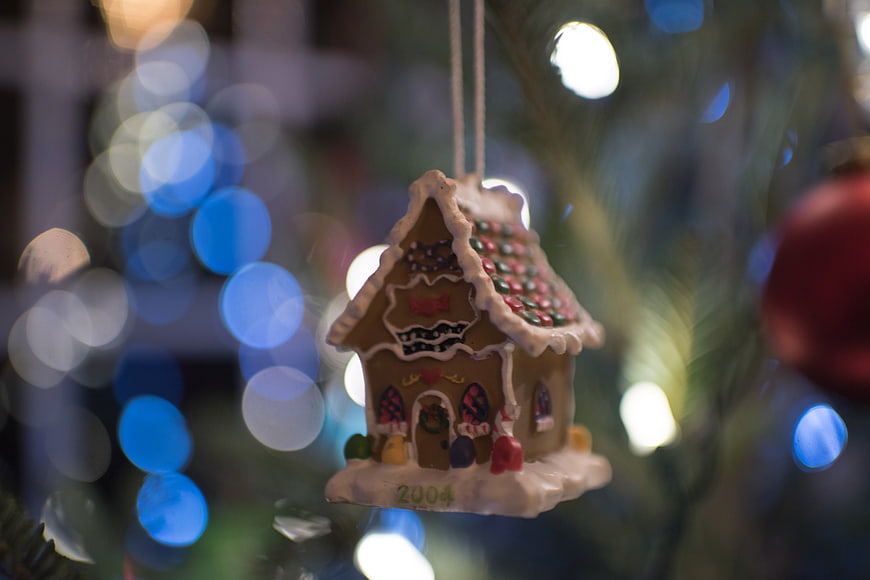 Gingerbread House Christmas Ornament on Tree with Bokeh Lights