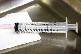 Medical Syringe On Gauze In Stainless Steel Tray