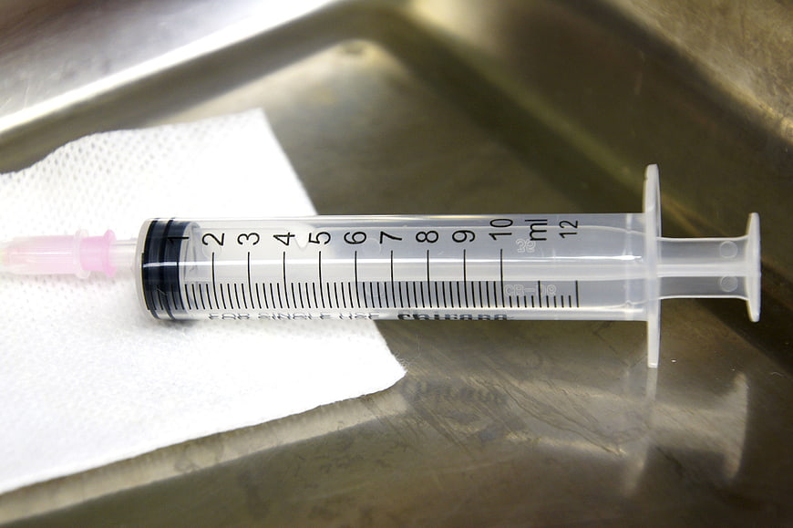 Medical Syringe On Gauze In Stainless Steel Tray