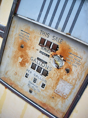Close-up of rusty vintage gas pump meter dial