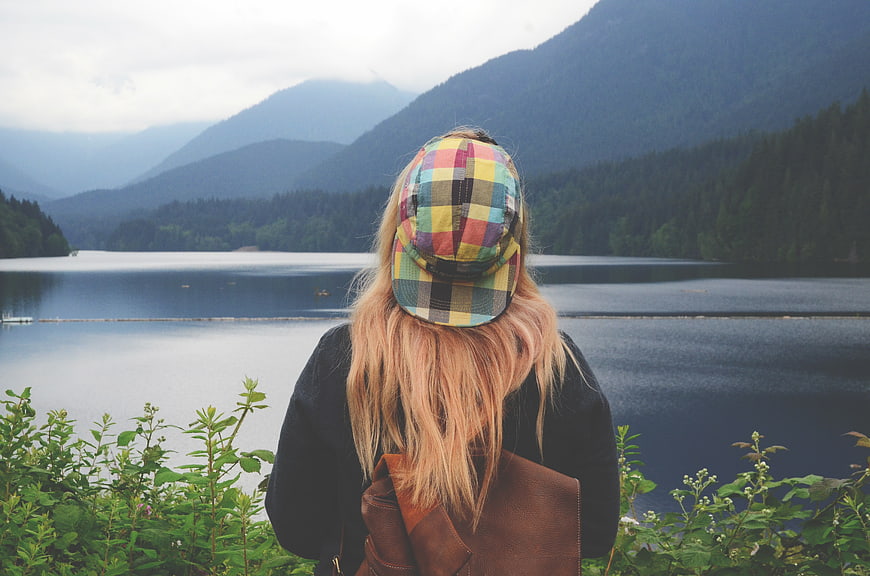 Woman with Colorful Plaid Cap Looking at Mountain Lake