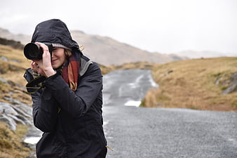 Woman Photographer Taking Pictures on Mountain Road
