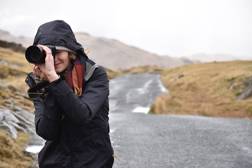 Woman Photographer Taking Pictures on Mountain Road