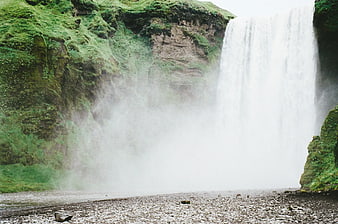Misty Skogafoss Waterfall in Iceland with Mossy Cliffs