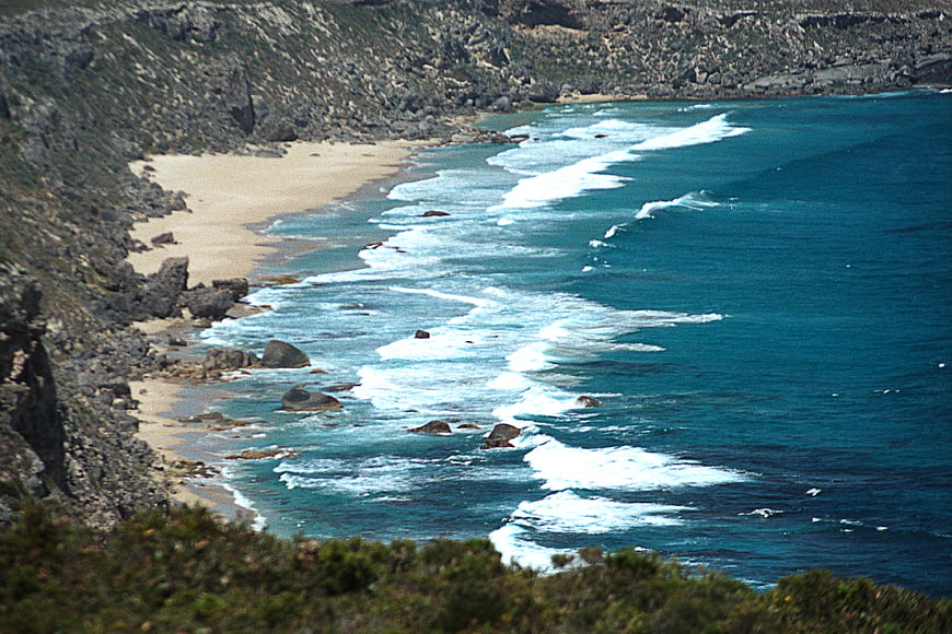 Aerial View of Secluded Sandy Cove with Turquoise Waves