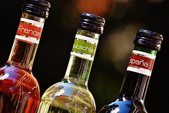 Close-up of wine bottles labeled France, Deutschland, and España