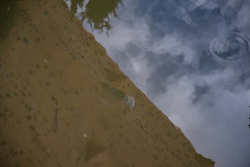Reflection of Rock Climber on Wet Wall in Rain