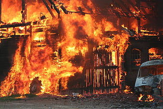 Intense Building Fire With Burning Vehicle And Collapsing Structure