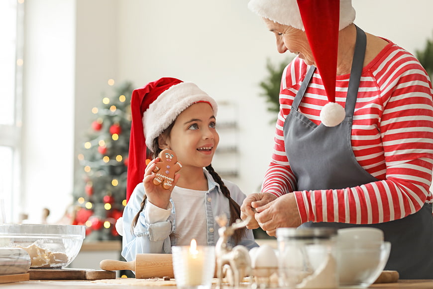 Grandmother and granddaughter baking Christmas cookies together
