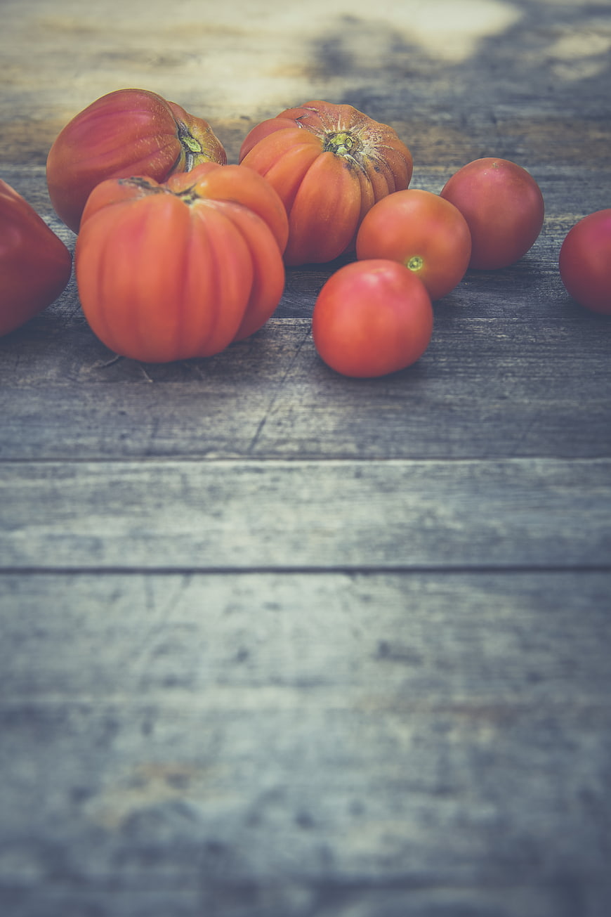 Fresh heirloom tomatoes on rustic wooden background