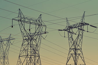 Silhouetted High Voltage Power Lines Against Gradient Sky