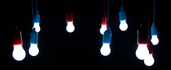 Colorful Hanging Light Bulbs Against Black Background