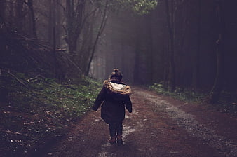 Woman Walking Away on Misty Forest Path