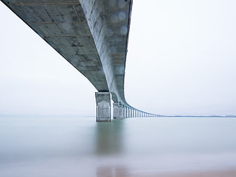 Long Exposure View Under Massive Concrete Bridge Pier