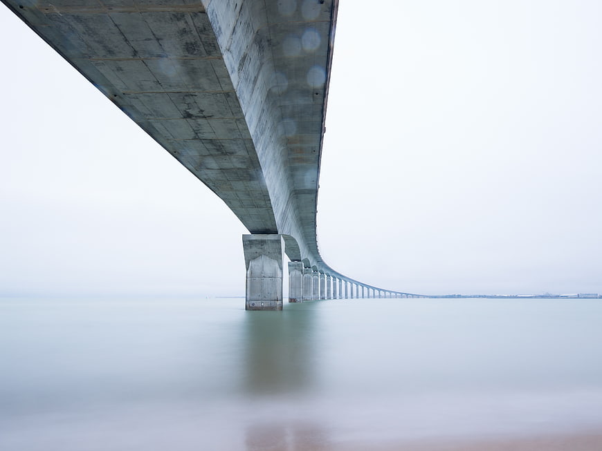 Long Exposure View Under Massive Concrete Bridge Pier