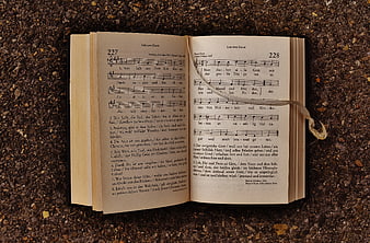 Open Hymnal Book on Gravel with Ribbon Bookmark