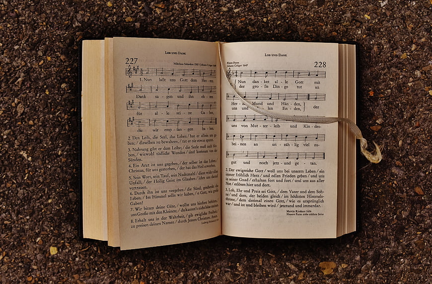 Open Hymnal Book on Gravel with Ribbon Bookmark