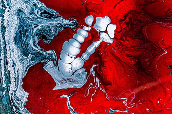 Abstract fluid art background with red, white, and blue ink swirls