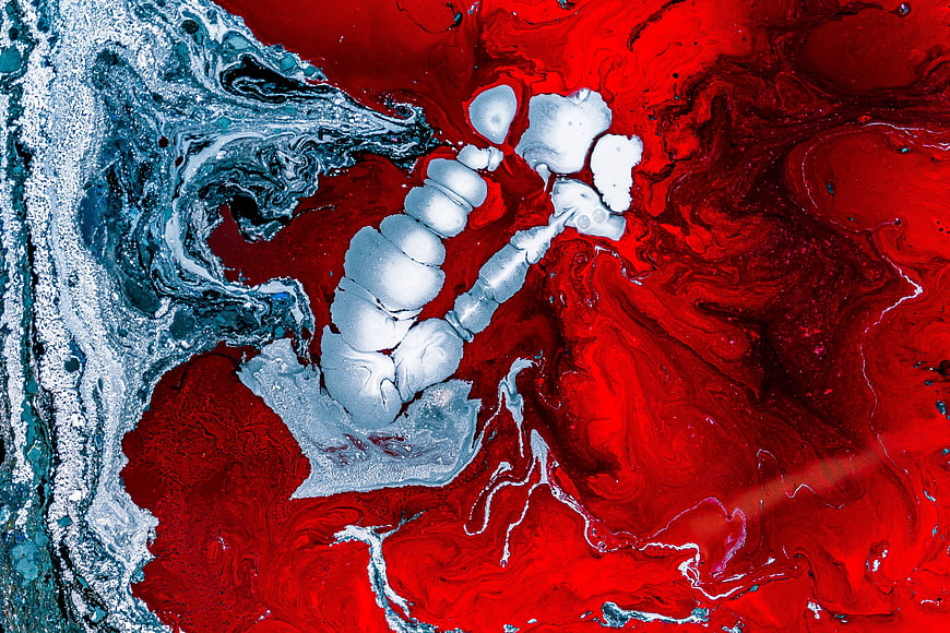 Abstract fluid art background with red, white, and blue ink swirls