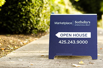 Blue Sotheby's Open House Real Estate Sign on Sidewalk