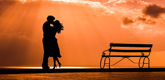 Silhouette of Romantic Couple Kissing at Sunset