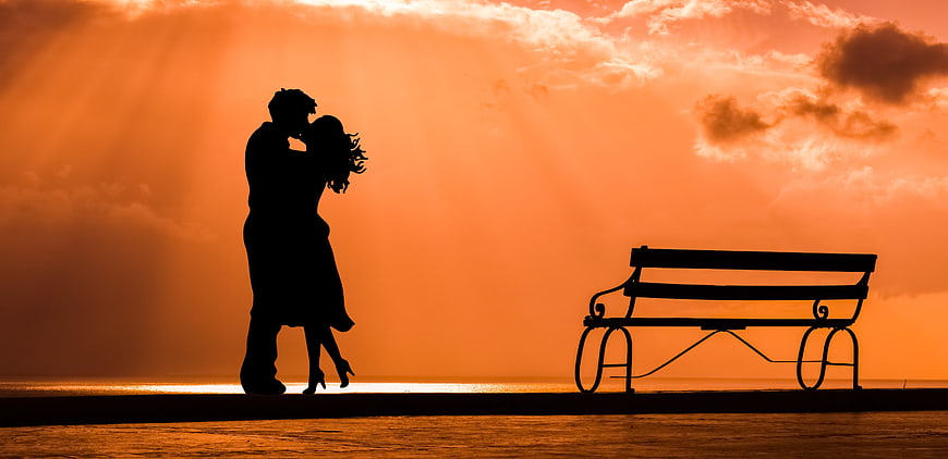 Silhouette of Romantic Couple Kissing at Sunset