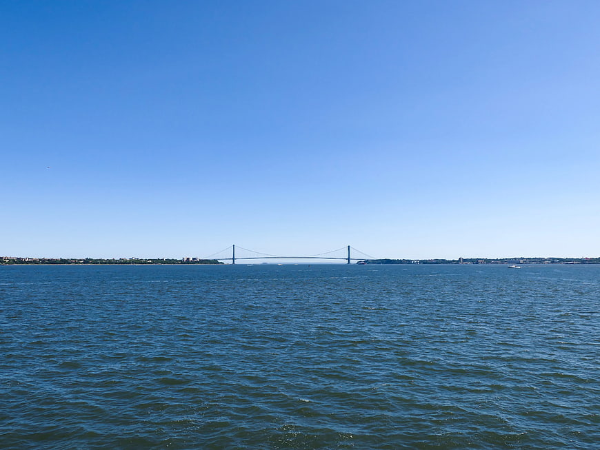 Wide view of suspension bridge over blue ocean water
