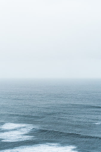 Minimalist Misty Ocean Horizon with Gentle Waves