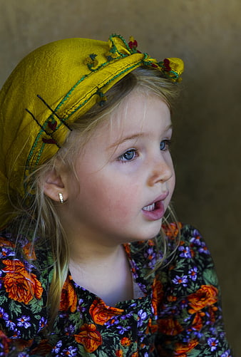 Portrait of young girl in traditional embroidered headscarf