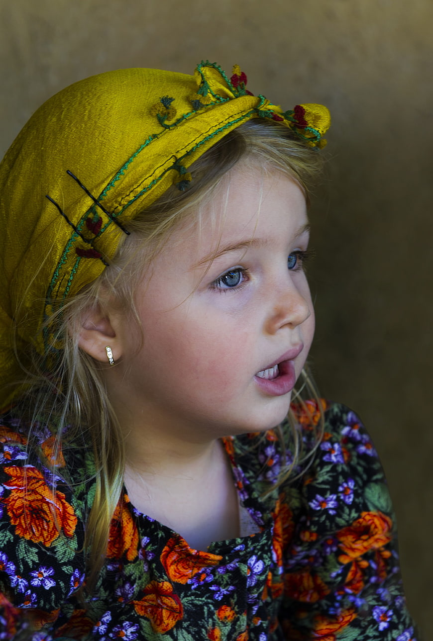 Portrait of young girl in traditional embroidered headscarf