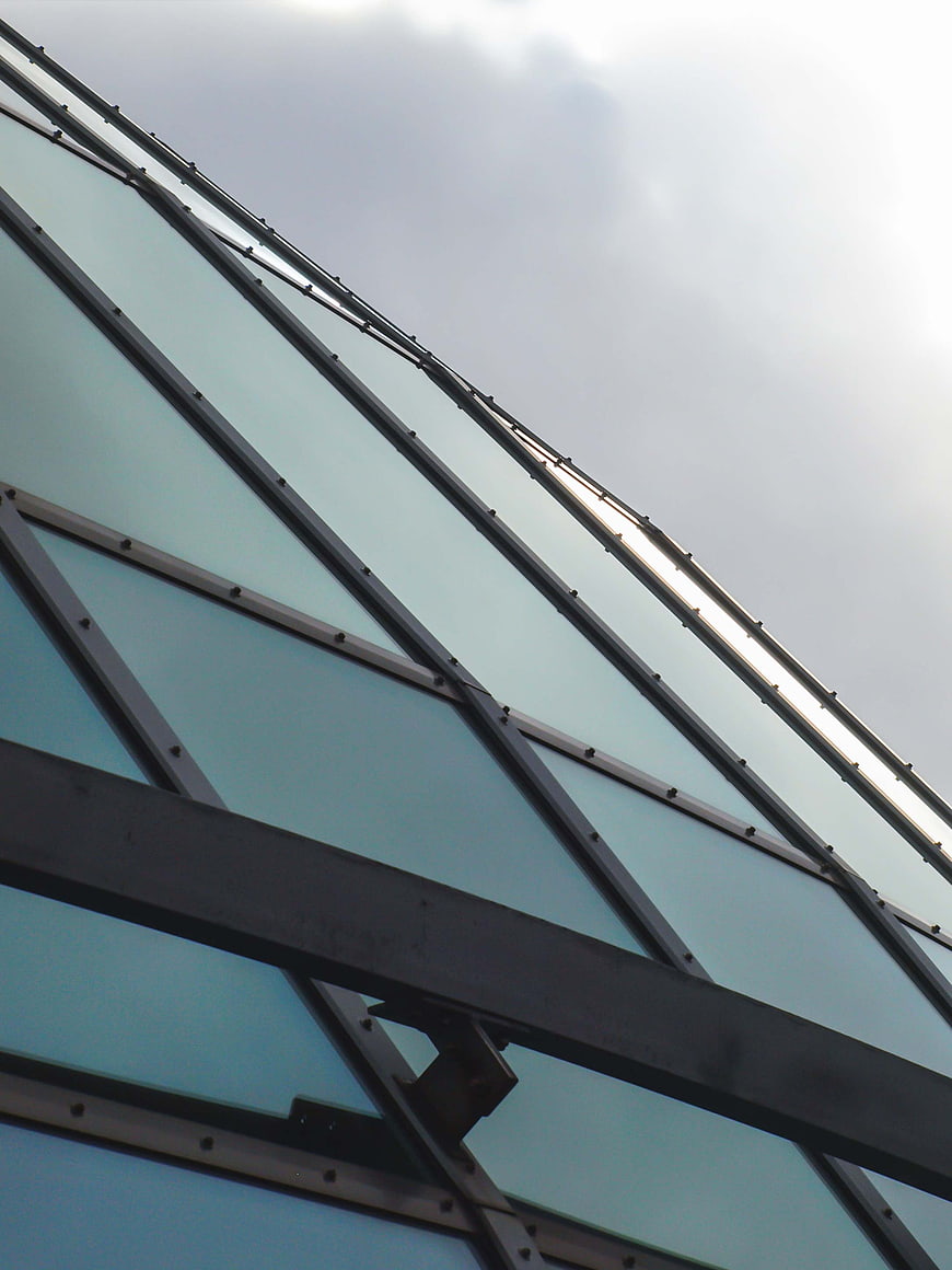 Abstract Modern Glass and Steel Architecture Against Sky