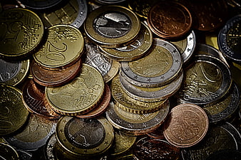 Close-up of scattered euro coins in gold, silver, and copper tones