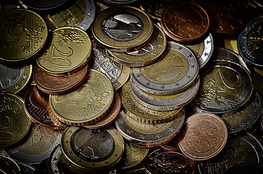Close-up of scattered euro coins in gold, silver, and copper tones