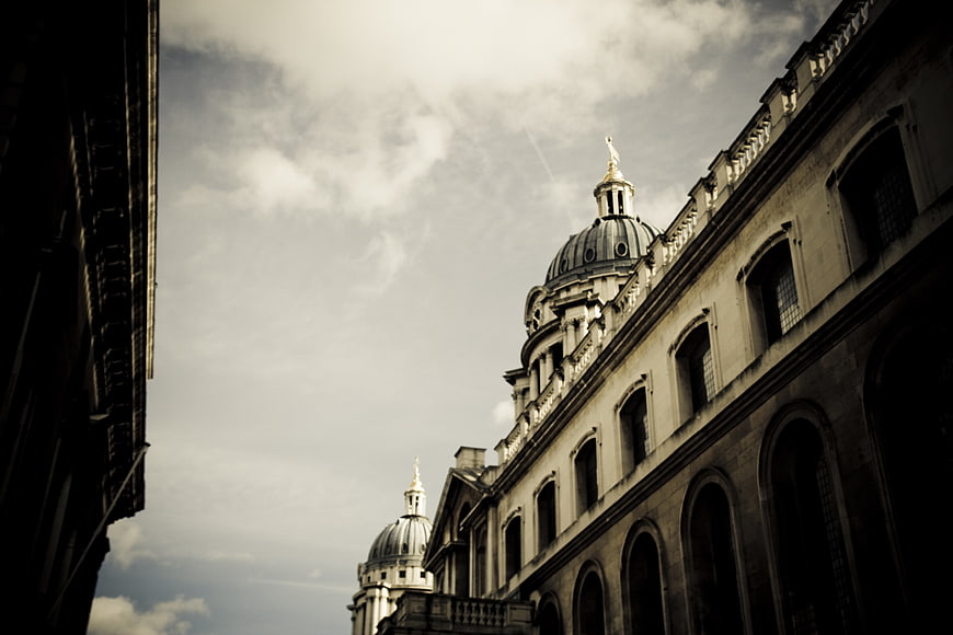 Low angle view of historic domed architecture against cloudy sky