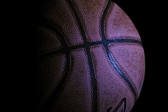 Close-up of textured basketball on black background