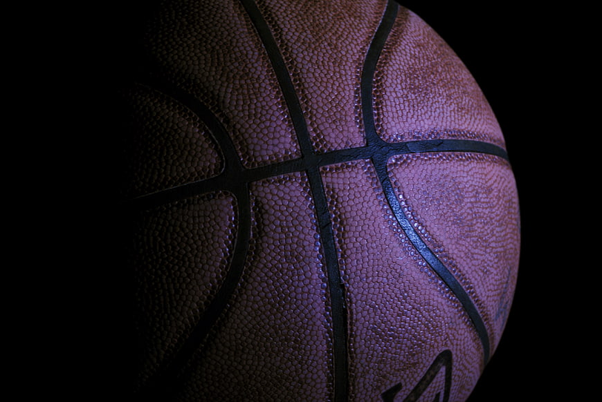 Close-up of textured basketball on black background