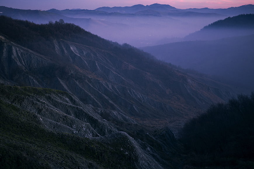 Misty purple hills at dusk in the Apennines