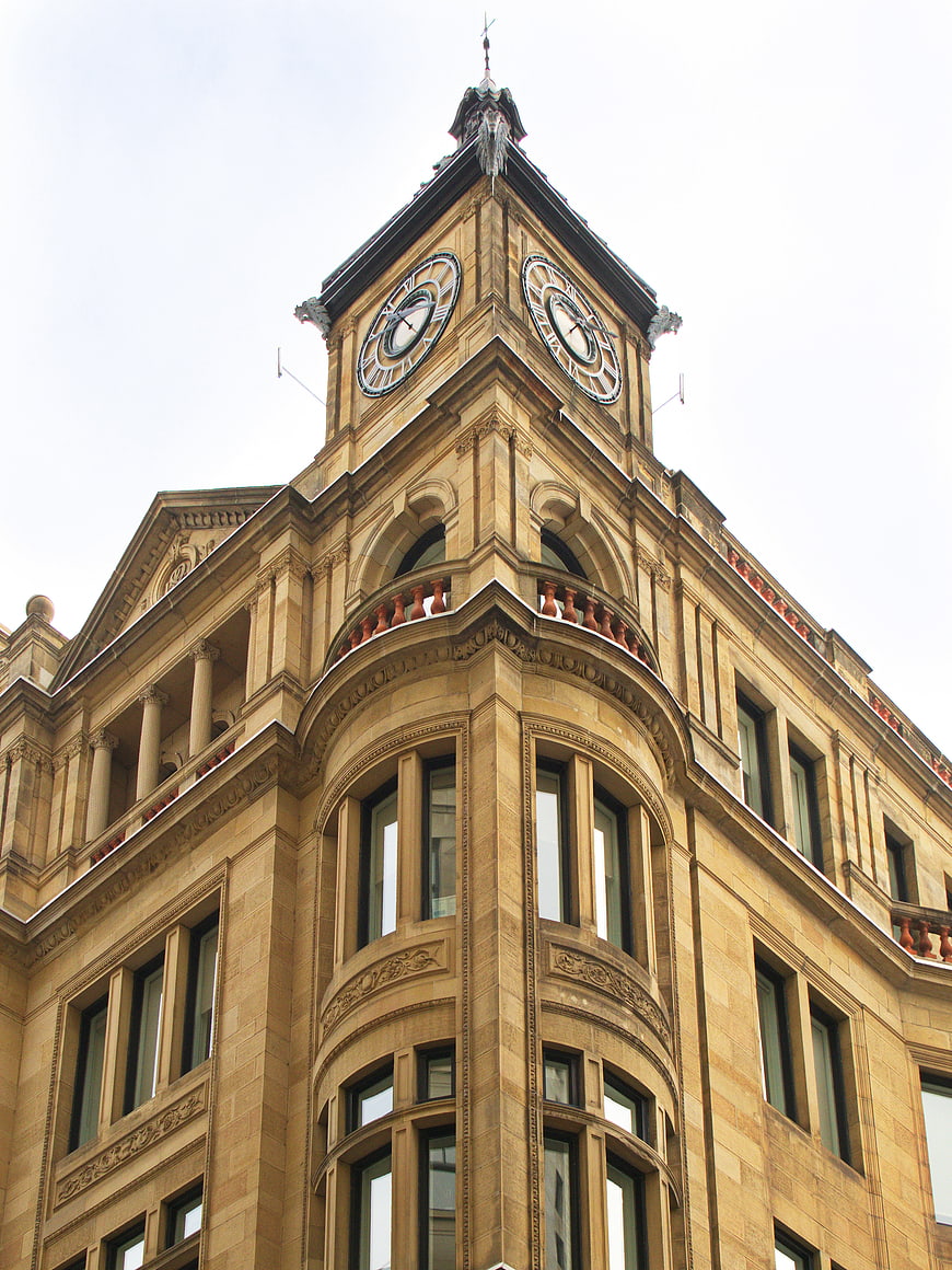 Low angle view of historic sandstone clock tower architecture