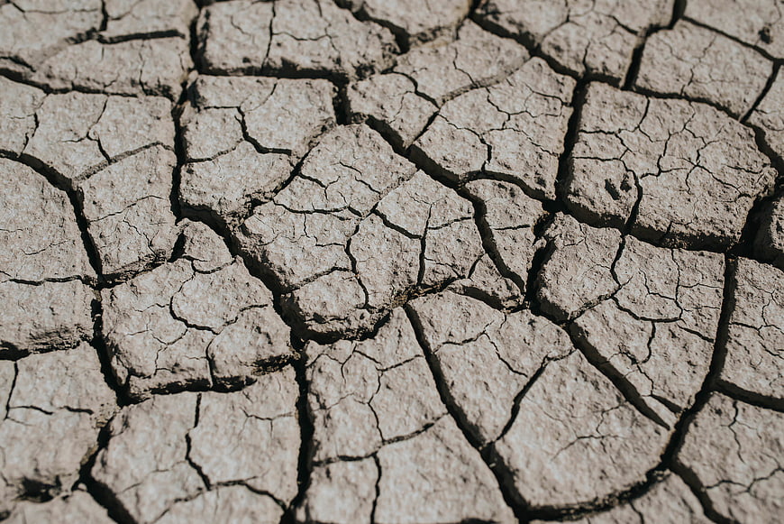 Close-up of cracked dry earth texture during drought