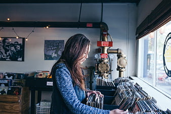 Woman browsing vinyl records in a record store